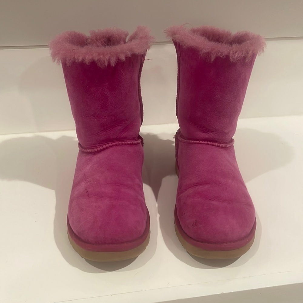 Pink Uggs with bows on back